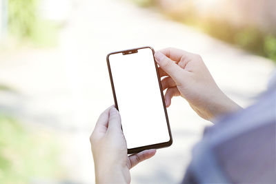 Midsection of person holding mobile phone