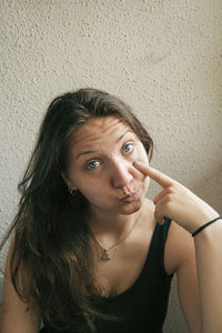 Young woman wearing against wall at home