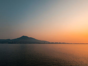 Orange sunset and blue sky colors the waterfront