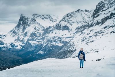 Full length of person standing on snowcapped mountain