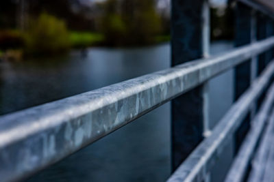 Close-up of railing by river