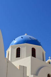 Low angle view of white building against clear blue sky