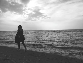 Rear view of man standing on beach