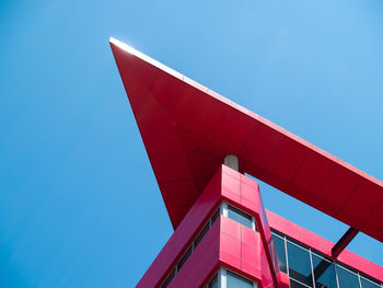 Low angle view of modern building against clear blue sky