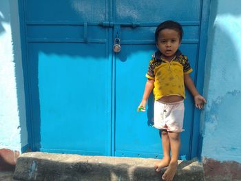 Small boy standing near the doors