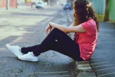 Full length of woman sitting on bench