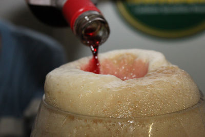 Close-up of ice pouring in glass