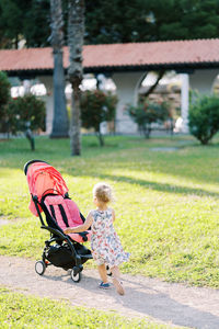 Rear view of woman sitting on park