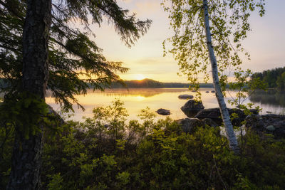 Scenic view of lake against sky at sunset
