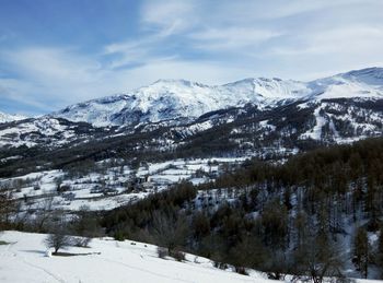 Scenic view of snowcapped mountains against sky