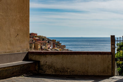 Scenic view of sea by building against sky