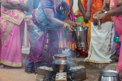 Full length of woman sitting at market stall