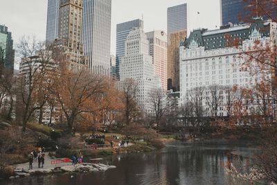 Buildings by river in city