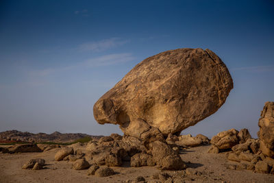Rock formation on land against sky