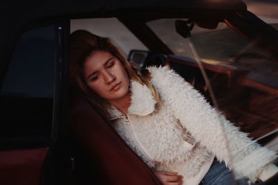 Portrait of smiling young woman in car