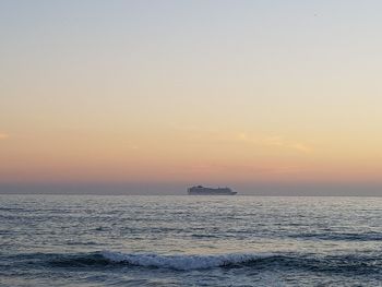 Scenic view of sea against clear sky during sunset