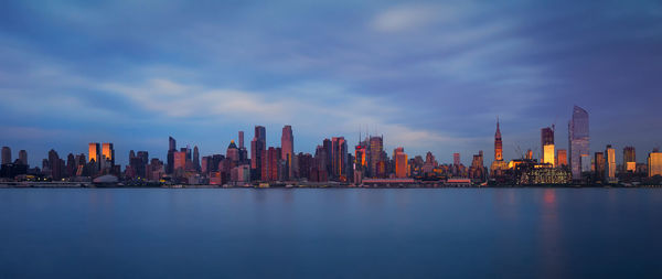 City at waterfront against sky