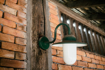 Low angle view of electric lamp on wall