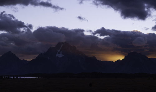 Scenic view of silhouette mountains against sky during sunset