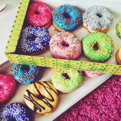 High angle view of donuts in cardboard boxes on rug