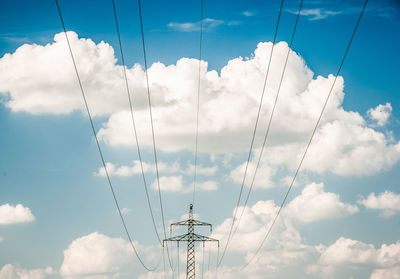 Low angle view of electricity pylon against sky