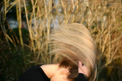Woman tossing hair outdoors