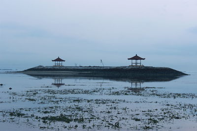 Gazebo in sea against sky