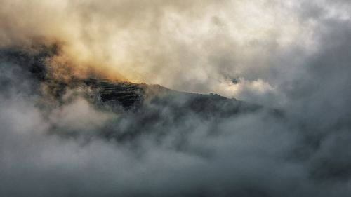 Majestic view of volcanic mountain against cloudy sky