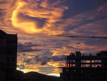 Low angle view of silhouette buildings against sky during sunset