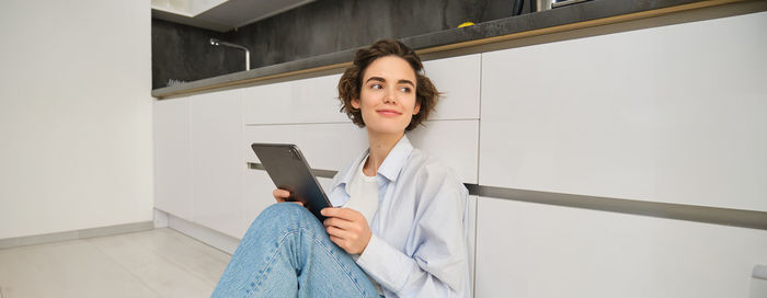 Portrait of young businesswoman working at home