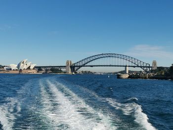 Bridge over sea against blue sky