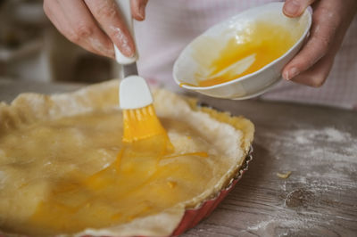 Cropped image of woman preparing apple pie