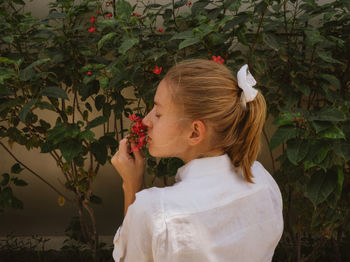 Woman enjoying smell of flowers