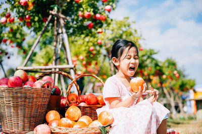 Portrait of smiling young woman holding wicker basket