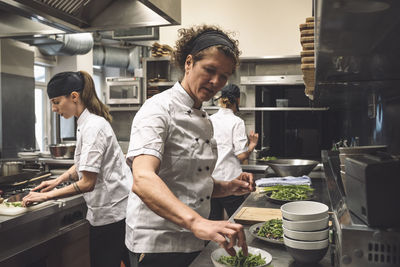 Female chefs working in commercial kitchen at restaurant