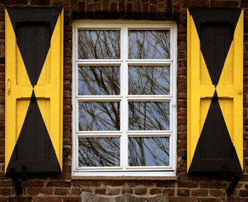Close-up of yellow window on building