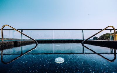 View of railing against blue sky