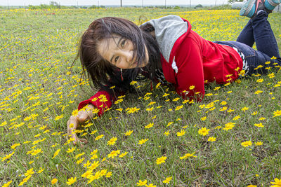 Full length of girl lying on field