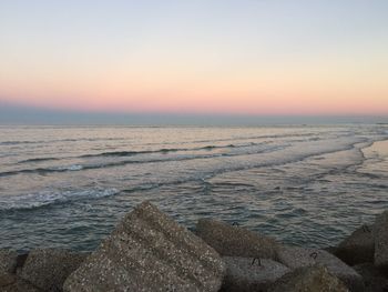 Scenic view of sea against clear sky during sunset