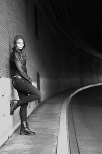 Full length portrait of woman standing in tunnel