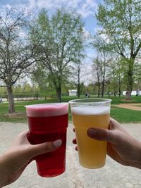 Midsection of woman holding beer glass