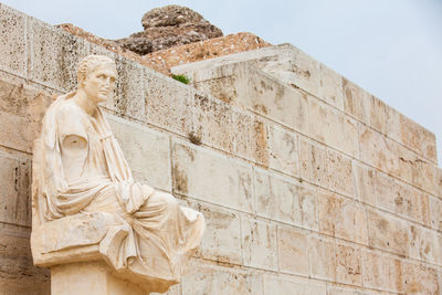 Low angle view of statue against wall