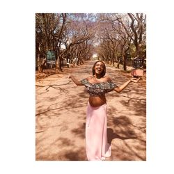 Portrait of smiling woman standing against trees