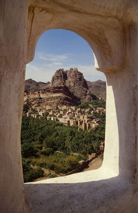 Scenic view of mountain seen through arch