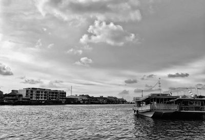 Scenic view of sea by buildings against sky