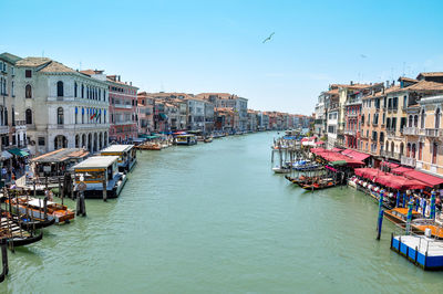 Panoramic view of boats in canal amidst buildings in city