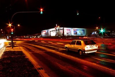 Illuminated city street at night