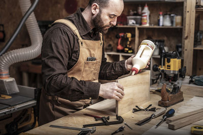 Man working at table in workshop