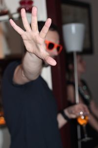 Young man gesturing stop sign at party