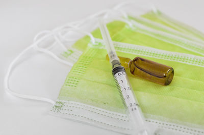 Close-up of colored pencils on table against white background